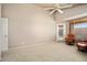Bright bedroom featuring neutral tones, plush carpet, a ceiling fan, and a private exterior entry at 18123 W Hayden Dr, Surprise, AZ 85374