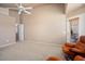The bedroom features carpet floors, a fan, natural light from multiple windows, and outdoor access at 18123 W Hayden Dr, Surprise, AZ 85374