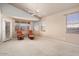 The bedroom features carpet floors, a fan, and natural light from multiple windows at 18123 W Hayden Dr, Surprise, AZ 85374