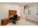 Bedroom featuring a built-in desk for working from home and tiled flooring at the entrance at 18123 W Hayden Dr, Surprise, AZ 85374