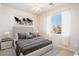 Bedroom features neutral tones, plush carpet, a ceiling fan, and a large window for ample light at 18123 W Hayden Dr, Surprise, AZ 85374