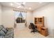Bedroom with a fan, window, and desk providing functional workspace at 18123 W Hayden Dr, Surprise, AZ 85374
