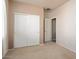 Bedroom showcasing a closet with sliding doors and an adjacent doorway with a white-painted trim at 18123 W Hayden Dr, Surprise, AZ 85374