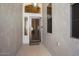A covered entry with a decorative front door and sidelight windows provides curb appeal at 18123 W Hayden Dr, Surprise, AZ 85374