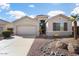 Charming single-story home features a well-manicured front yard and attached two-car garage at 18123 W Hayden Dr, Surprise, AZ 85374