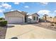 Charming single-story home with a two car garage, desert landscaping, and a spacious driveway at 18123 W Hayden Dr, Surprise, AZ 85374