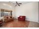 Well-lit living area with neutral walls, tile flooring, and a ceiling fan at 18123 W Hayden Dr, Surprise, AZ 85374