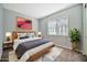 Stylish bedroom with modern decor, including a wooden bedframe, plants, and modern lamps at 18508 W Galveston St, Goodyear, AZ 85338