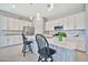 Spacious kitchen with an island, modern appliances, and sleek white cabinetry at 18508 W Galveston St, Goodyear, AZ 85338