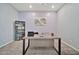 Bright home office featuring gray walls, carpet and a modern desk with a bookcase at 18508 W Galveston St, Goodyear, AZ 85338