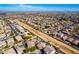 High aerial view of a desert neighborhood with similar style houses and community areas at 19221 N Toya St, Maricopa, AZ 85138