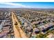 Wide aerial of a desert community highlighting uniform homes, streets, and landscape at 19221 N Toya St, Maricopa, AZ 85138