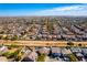 Areal view of desert neighborhood with swimming pools and mountains in the distance at 19221 N Toya St, Maricopa, AZ 85138