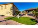 Expansive backyard with lush landscaping, covered patio, and charming garden accents at 19221 N Toya St, Maricopa, AZ 85138