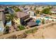 Aerial shot of a backyard featuring a pool, gazebo, covered patio, and mature palm tree at 19221 N Toya St, Maricopa, AZ 85138