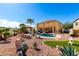 Backyard featuring a pool, rock landscaping, lounge chairs, and a covered patio at 19221 N Toya St, Maricopa, AZ 85138