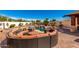 Resort-style backyard with sparkling pool, outdoor seating, rock waterfall and covered pavilion at 19221 N Toya St, Maricopa, AZ 85138