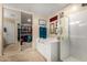 Bright bathroom featuring a soaking tub, walk-in shower, and a walk-in closet with mirrored sliding doors at 19221 N Toya St, Maricopa, AZ 85138