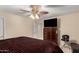 Bedroom featuring a large TV atop a wooden dresser, neutral walls, and a plush brown comforter on the bed at 19221 N Toya St, Maricopa, AZ 85138