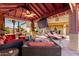 Relaxing covered patio features ample seating, a mounted TV, and offers outdoor living space at 19221 N Toya St, Maricopa, AZ 85138
