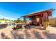 Outdoor covered patio with a pool view offering lounge seating and access to backyard amenities at 19221 N Toya St, Maricopa, AZ 85138