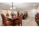 Formal dining room with ornate wood table and chairs, with a living space and entertainment center visible at 19221 N Toya St, Maricopa, AZ 85138