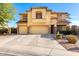 Two-story tan stucco home with a three-car garage and mature landscaping at 19221 N Toya St, Maricopa, AZ 85138