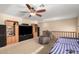 Upstairs living area with a large TV, comfortable seating, and a relaxing ambiance with a ceiling fan at 19221 N Toya St, Maricopa, AZ 85138
