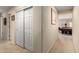 Hallway leading to the game room with neutral walls and convenient closet space at 19221 N Toya St, Maricopa, AZ 85138