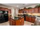 Kitchen island with granite countertop, stainless steel appliances, and hardwood cabinets offering ample counter space at 19221 N Toya St, Maricopa, AZ 85138