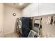 Laundry room with white cabinets, a front load washer and dryer set, and neutral colored walls at 19221 N Toya St, Maricopa, AZ 85138
