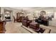 Living room featuring a leather armchair, formal dining set, and workspace with mirrored wall accents at 19221 N Toya St, Maricopa, AZ 85138