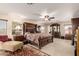 Expansive main bedroom with a luxurious bed, elegant furnishings, and plush carpeting at 19221 N Toya St, Maricopa, AZ 85138