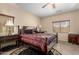 Spacious bedroom featuring a patterned bed, ceiling fan, and classic furnishings at 19221 N Toya St, Maricopa, AZ 85138