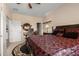 Spacious bedroom features a patterned bed, ceiling fan, and a desk in the corner at 19221 N Toya St, Maricopa, AZ 85138