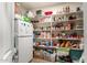 Spacious walk-in pantry with ample shelving and storage space, plus a convenient secondary refrigerator at 19221 N Toya St, Maricopa, AZ 85138