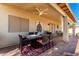 Covered patio featuring a ceiling fan, a dining table with chairs, and neutral colored walls at 19221 N Toya St, Maricopa, AZ 85138