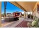 Covered patio featuring a large lounge area and an outdoor kitchen at 19221 N Toya St, Maricopa, AZ 85138