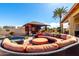Inviting backyard patio with comfortable seating, desert landscaping and clear blue skies at 19221 N Toya St, Maricopa, AZ 85138