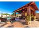 Outdoor covered pavilion featuring comfortable seating and lush backyard landscape at 19221 N Toya St, Maricopa, AZ 85138