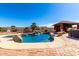Inviting backyard pool with rock waterfall, swim up bar, covered pavilion, brick patio and desert landscaping at 19221 N Toya St, Maricopa, AZ 85138