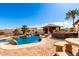 Inviting backyard pool with rock waterfall, swim up bar, covered pavilion, brick patio and desert landscaping at 19221 N Toya St, Maricopa, AZ 85138