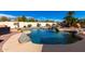 Beautiful swimming pool with custom rock waterfall feature and lush desert landscaping at 19221 N Toya St, Maricopa, AZ 85138