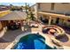 Inviting pool area with sun loungers, custom seating, and a covered outdoor kitchen at 19221 N Toya St, Maricopa, AZ 85138