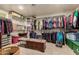 This walk-in closet is equipped with ample shelving, hanging racks, and a storage bench at 19221 N Toya St, Maricopa, AZ 85138