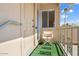 Cozy balcony seating area with a view of blue sky, palm trees, and cactus at 19410 N Star Ridge Dr, Sun City West, AZ 85375