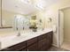 Bright bathroom with double sink vanity and well lit mirror at 19700 N 76Th St # 1080, Scottsdale, AZ 85255