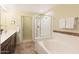 Bathroom featuring a soaking tub, walk-in shower, and vanity at 19700 N 76Th St # 1080, Scottsdale, AZ 85255