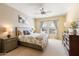 Well-lit bedroom featuring neutral tones, soft carpet and a ceiling fan at 19700 N 76Th St # 1080, Scottsdale, AZ 85255