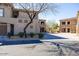 Condo exterior featuring two stories with stucco, stone accents, and a well-maintained parking area at 19700 N 76Th St # 1080, Scottsdale, AZ 85255
